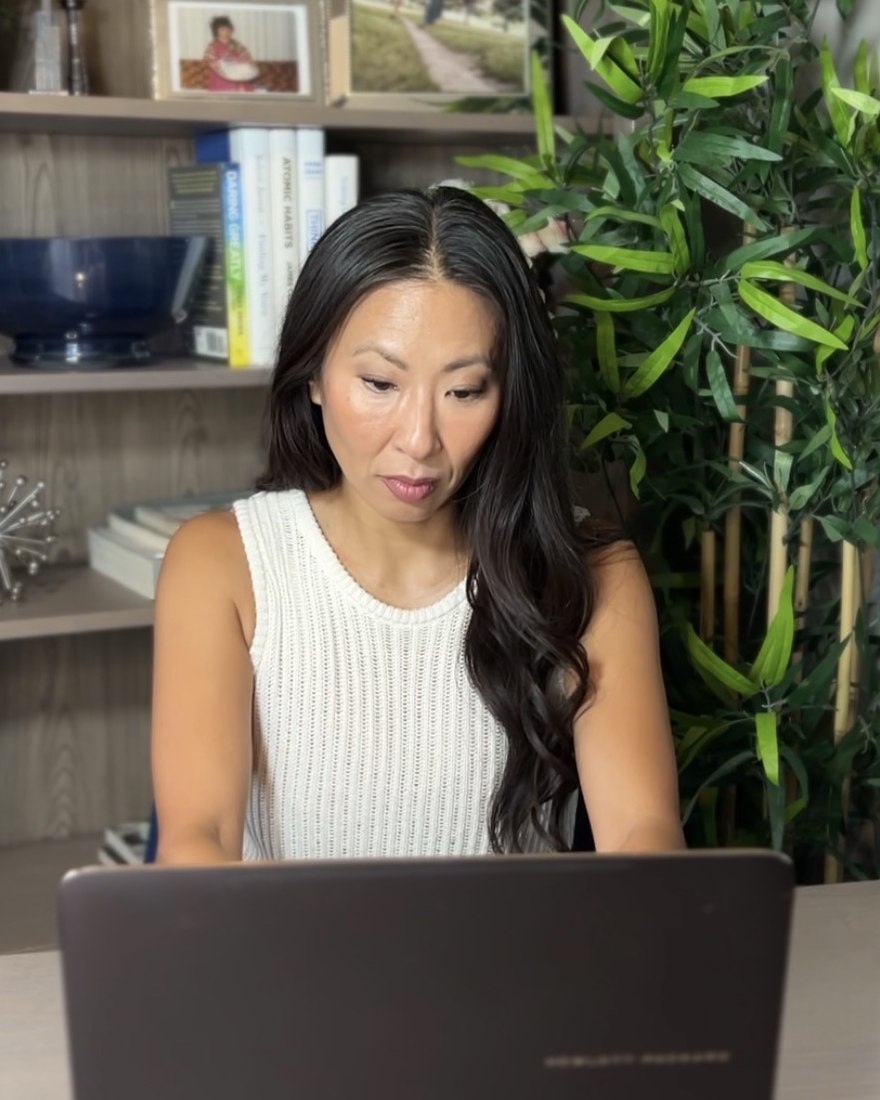 Jaimie Higgins working at her desk on a laptop
